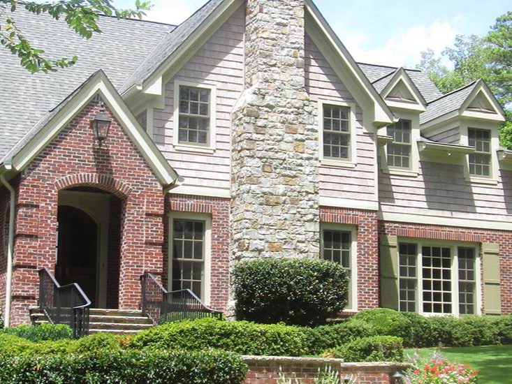 Brick and shake-sided Atlanta home with landscaped front yard.