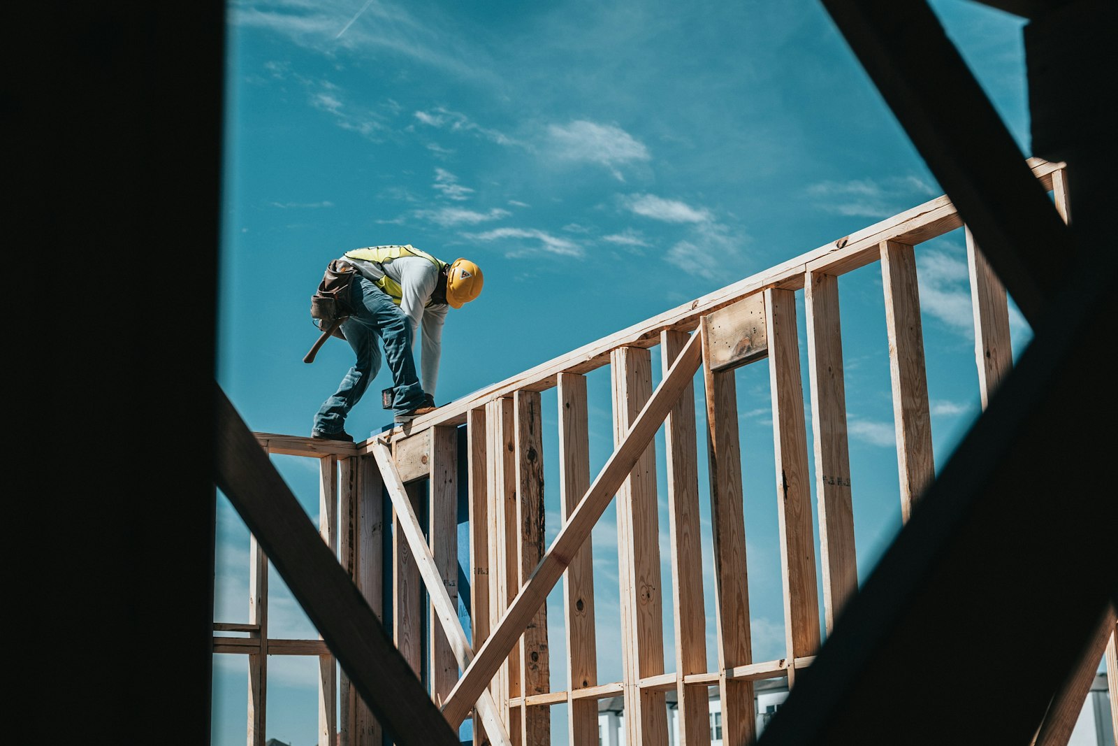 Framer working on the roof trusses of a new home under construction
